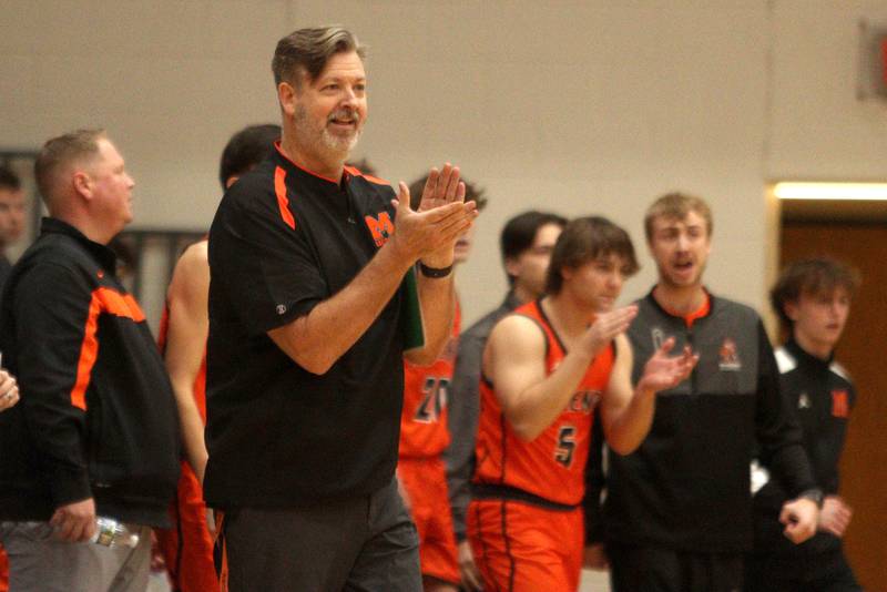 McHenry’s Head Coach Corky Card guides the Warriors against Kaneland in Hoops for Healing basketball tournament championship game action at Woodstock Wednesday.