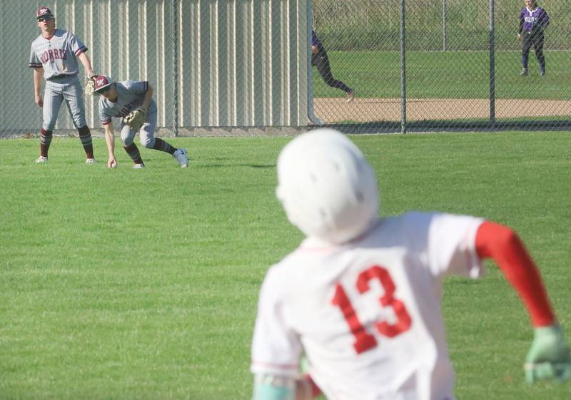 Ottawa's Rizon Contreras rounds first base as the ball travles to Morris's Grady Hutchcraft while teammate Caden Medler watches on Monday, April 20, 2026 at Ottawa High School.