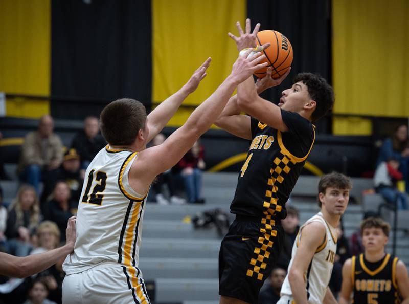 Reed-Custer's Chase Isaac, right, elevates for a shot as Herscher's Gavin Hull defends in a game on Wednesday, November 26, 2025.