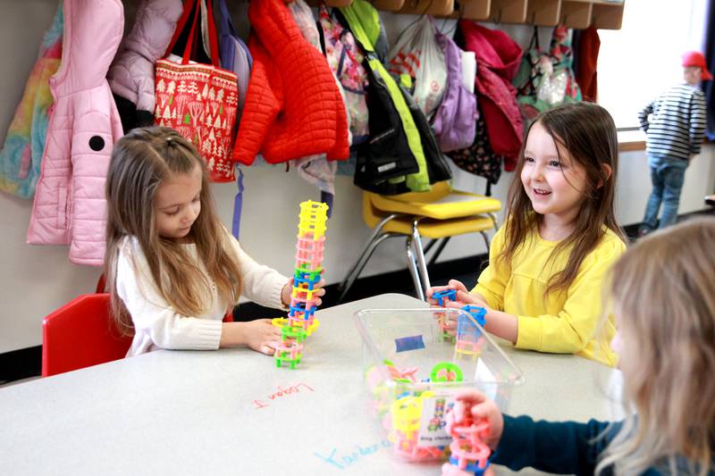 Students Bea (left) and Olivia build towers at the Fox Valley YMCA Central Branch’s Early Learning Academy in Plano.