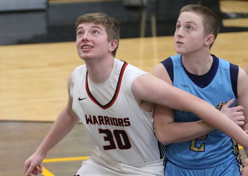 Woodland's Zane Drysdale blocks out Marquettes Ben Walker for a rebound during the Tri-County Conference Tournament championship on Friday, Jan. 30, 2026 at Putnam County High School.
