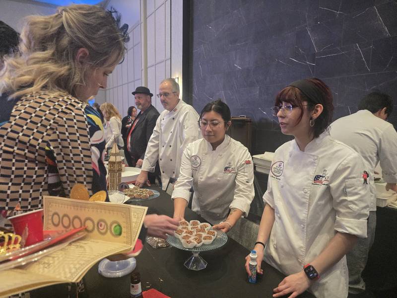 Joliet Junior College culinary arts students under the direction of chef instructor Mark Muszynski (left in white lab coat) at the Shorewood HUGS' "Lovely London: A Big Ben Bash" 2026 chocolate ball fundraiser on Saturday, Feb. 7, 2026, at Hollywood Casino Joliet.