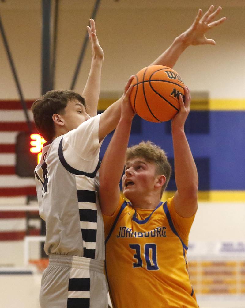 Johnsburg's Jayce Schmitt drives to the basket against Cary-Grove's Dylan Dumele during a Johnsburg Thanksgiving Tournament boys basketball game on Monday, Nov. 24, 2025, at Johnsburg High School.