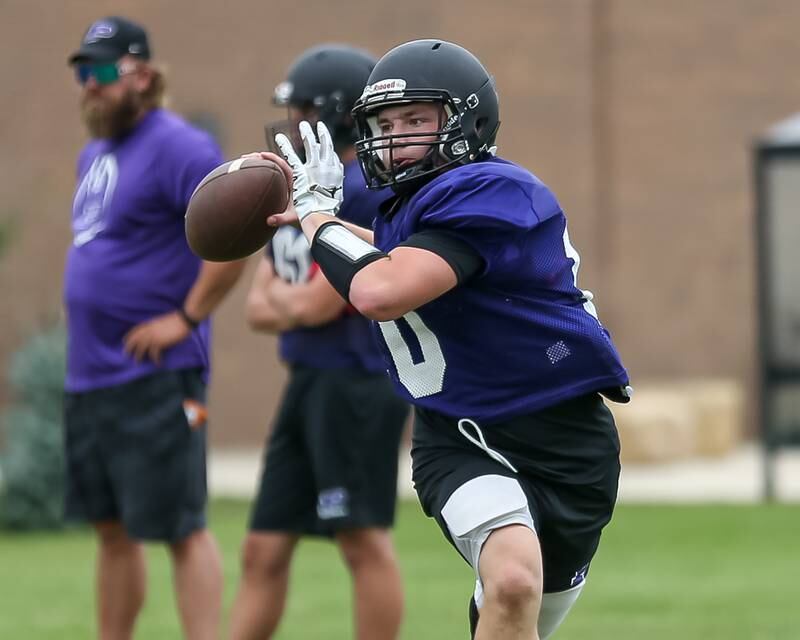Kaiden Shimandle rolls out to pass at Plano High School football practice.  August 9, 2023.