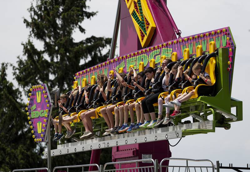 Carnivalgoers ride The Edge during the Spring Fling in Westmont, Ill. on Sunday, May 29, 2022.