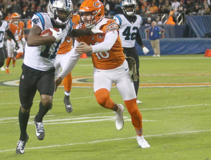 Carolina Panthers wide receiver Ihmir Smith-Marsette pushes Chicago Bears punter Trenton Gill away as he scores a touchdown on a punt on Thursday, Nov. 9, 2023 at Soldier Field.