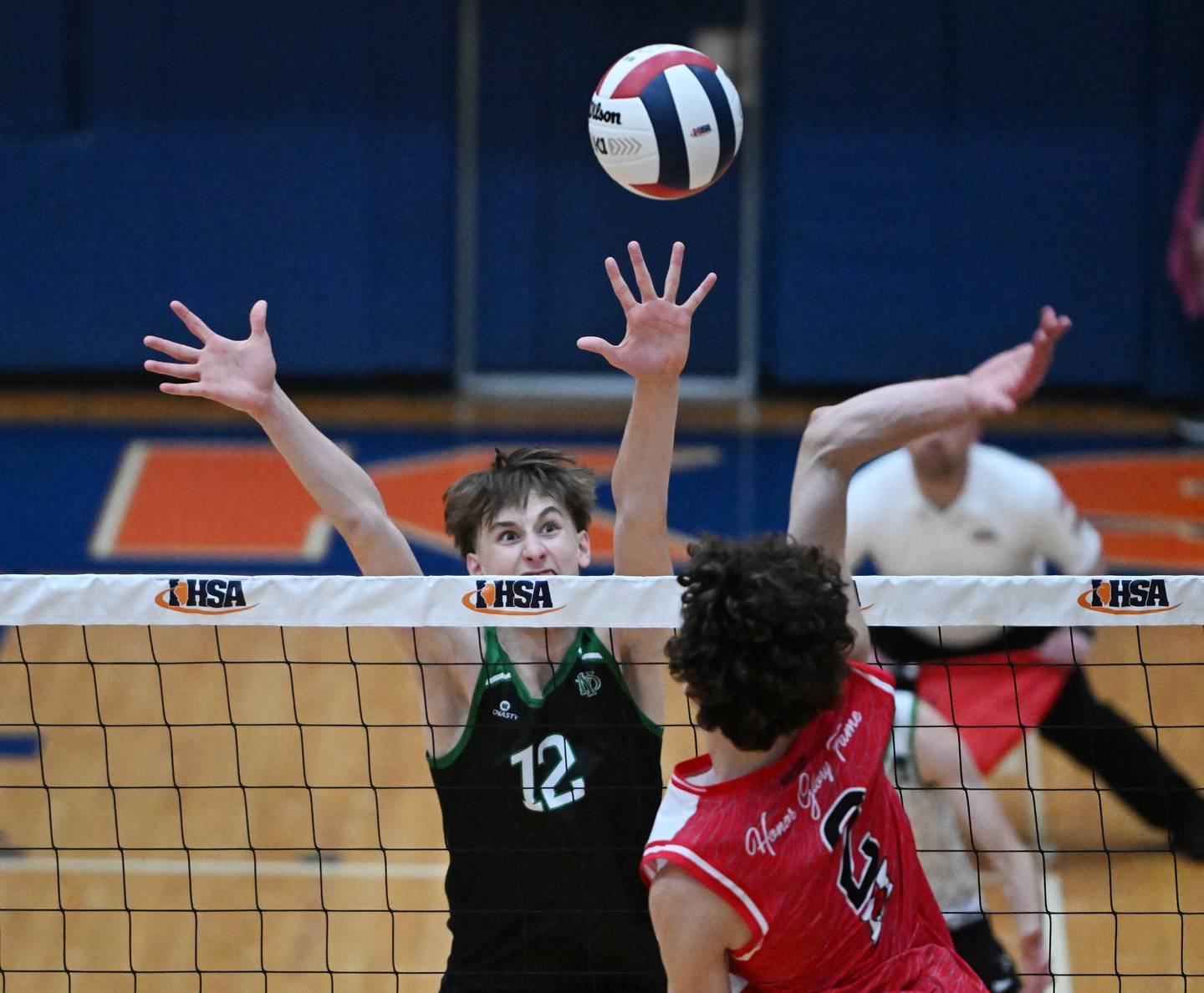 York's Ben Brown (12) locks his eyes on the ball as he attempts to block the hit by Marist's Christian Teresi during the IHSA state boys volleyball championship match on Saturday, June 1, 2024 in Hoffman Estates.