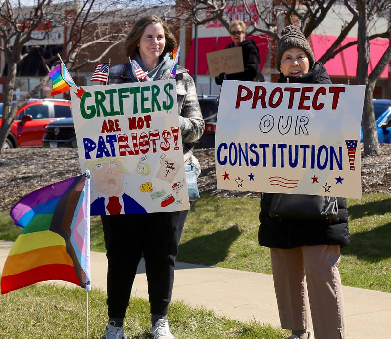 Protesters hold signs at the No Kings demonstration along U.S. Route 34 in Oswego on Saturday, March 28, 2026.