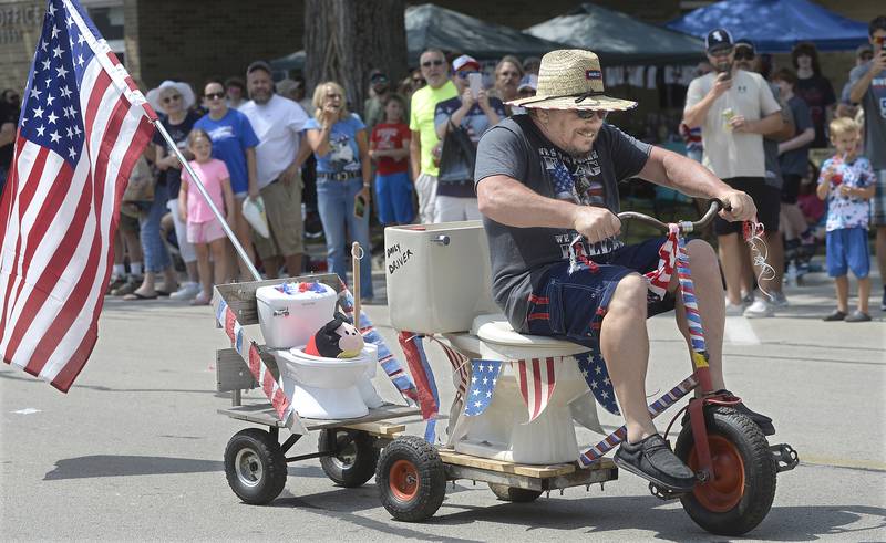 Paul Brennan pedals down Si Johnson Avenue in his Toilet Cycle during Tuesday’s Toilet Bowl Races as part of Sheridan’s 4th of July celebration.