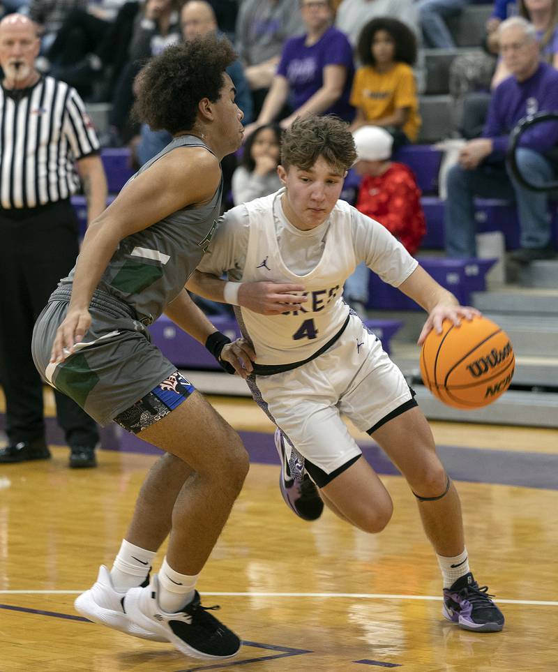 Dixon’s Brody Nicklaus drives by Plainfield Central’s Phoenix Jones Friday, Jan. 3, 2025, at Dixon High School.