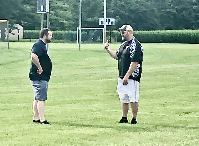 Bureau Valley coach Mat Pistole (left) and Princeton coach Ryan Pearson talk prior to the July 7-on-7 at Princeton. Both teams await the first day of practice on Monday.