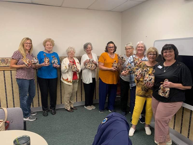 Ann Goy, Sharon Presse, Margaret Carr, Lonnie Schaefer, Donna Jungnickel, Alice Giberson, Jan Koch, Carolyn Schultz and Amanda Simpson display finished veterans’ goodie bags during a recent Fort du Rocher Chapter of the Daughters of the American Revolution meeting.