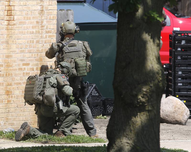 Law enforcement from area departments surround a home on Thursday, June 5, 2025, in the area of Venice Avenue and Court Street in McHenry.