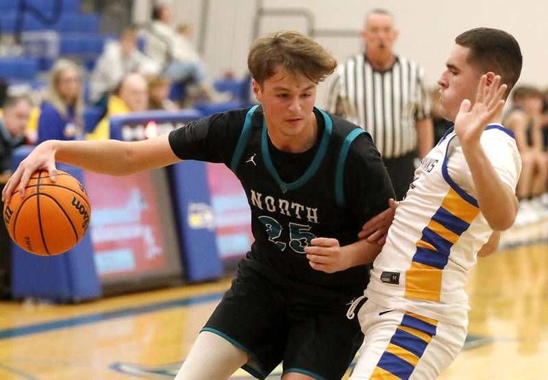 Woodstock North's AJ Cohen drives the baseline against Johnsburg's Ryan Franze during a Kishwaukee River Conference boys basketball game on Monday, Dec. 15, 2025, at Johnsburg High School.