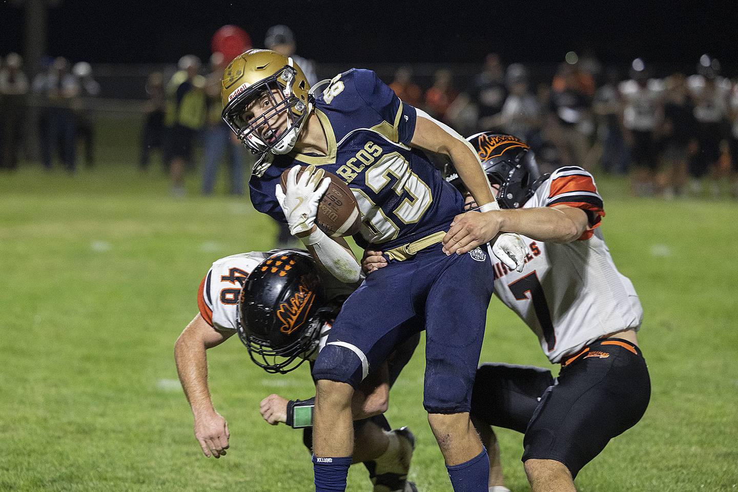 Polo’s Mercer Mumford is tackled by Milledgeville’s Spencer Nye (left) and Konner Johnson Friday, Sept. 19, 2025.