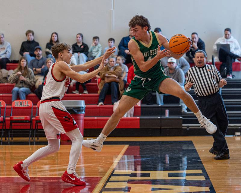 Gino Ferrari (4) of St. Bede leaps and catches ball before falling out of bounds, then looks to throw it at Jacob Andracke (5) of Hall on Saturday, January 31, 2026 at Hall High School in Spring Valley.
