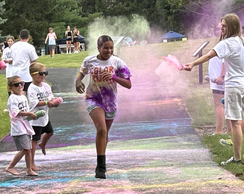 A runner navigates her way through one of the color stations at the Oregon Park District's color run on Tuesday, July 30, 2024.