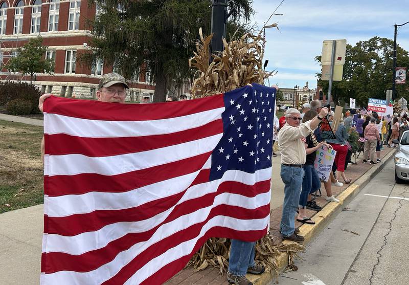Signs and American flags were carried by demonstrators on Saturday, Oct. 18, 2025 at the No Kings rally on the Ogle County Courthouse square in Oregon, Illinois.