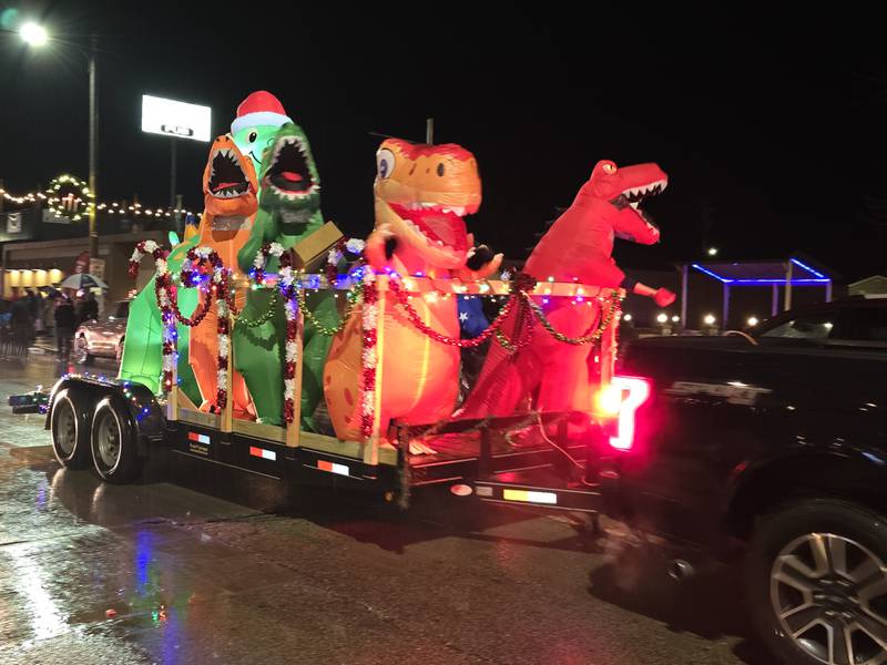 Inflatable dinosaurs roar through the Winter Wonderland parade Saturday, Dec. 14, 2024, in Oglesby.