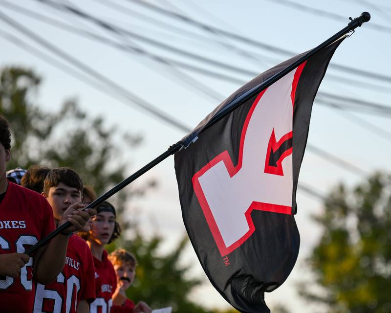 A Yorkville flag sways back and forth, held by a Yorkville football player while participating in the homecoming parade in Yorkville on Thursday, Sept. 28, 2023.