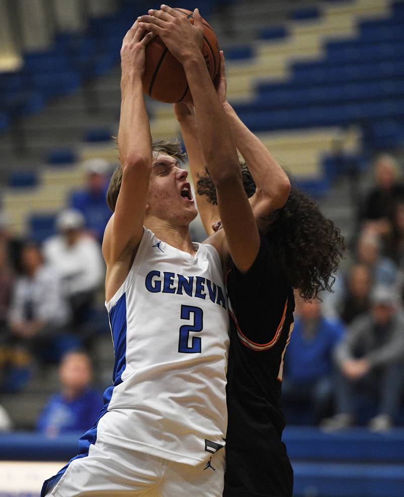 Geneva’s Michael Lawrence runs into the defense of Wheaton Warrenville South’s Braylen Meredith in a boys basketball game on Wednesday, December 7, 2022.