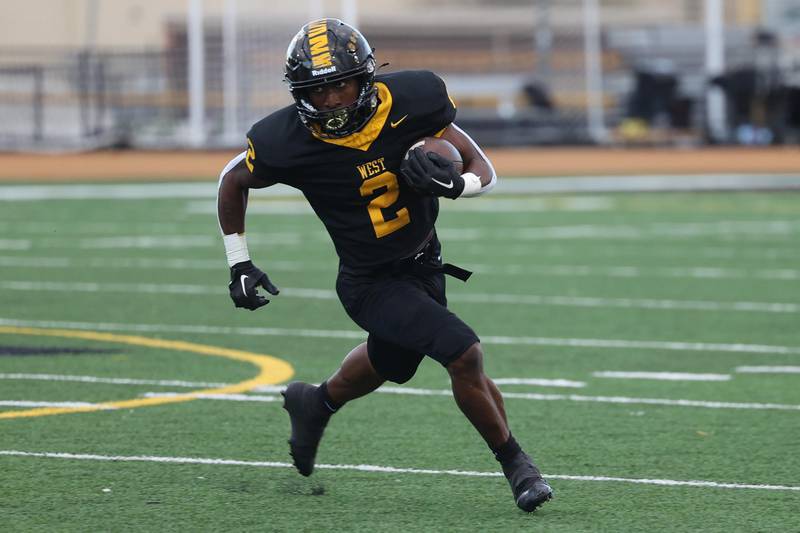 Joliet West’s Gerard Bush rushes to the outside against Morris on Friday, Sept. 6, 2024 in Joliet.