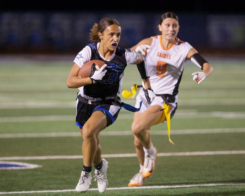 St. Charles North's  Alexandria Richardson runs the ball as St. Charles East's Ari Bigdai is in pursuit on Monday, September 29, 2025 in St. Charles.