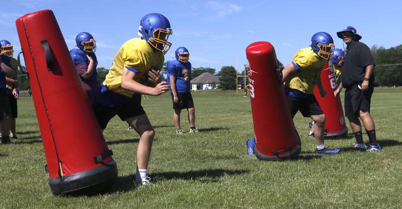 Johnsburg Assistant Coach Mark Landvick encourages players as they run tackling drills during summer football practice Thursday, June 23, 2022, at Johnsburg High School in Johnsburg.
