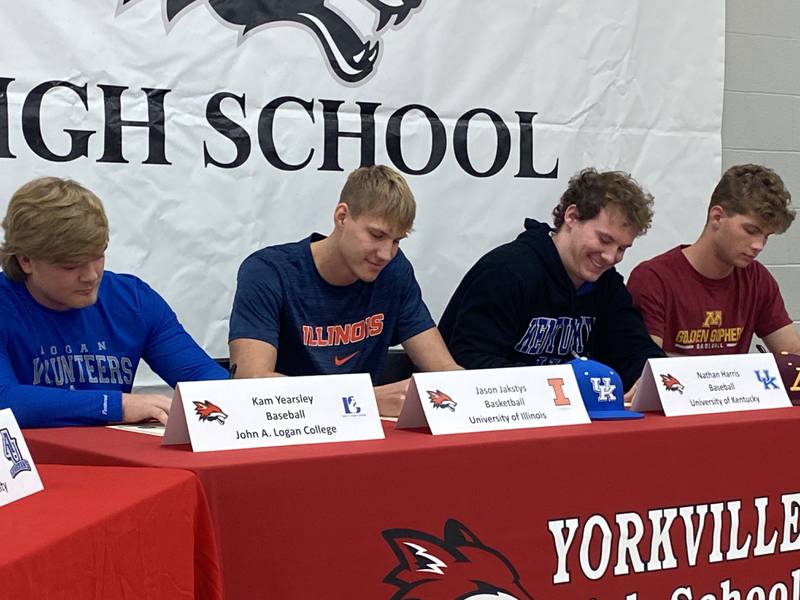 Yorkville senior Jason Jakstys (second from left) signs to play basketball at the University of Illinois on Wednesday, Nov. 9, 2023 in Yorkville.