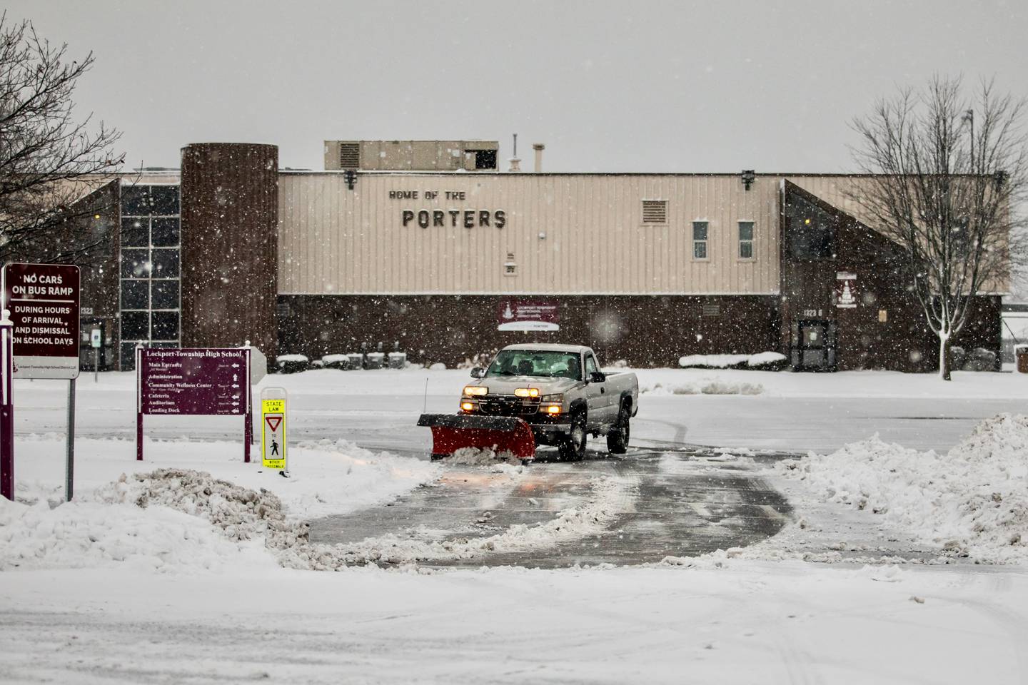 A plow clears snow at Lockport Township High School East Campus after the morning snowfall on Friday, Jan. 12, 2024.