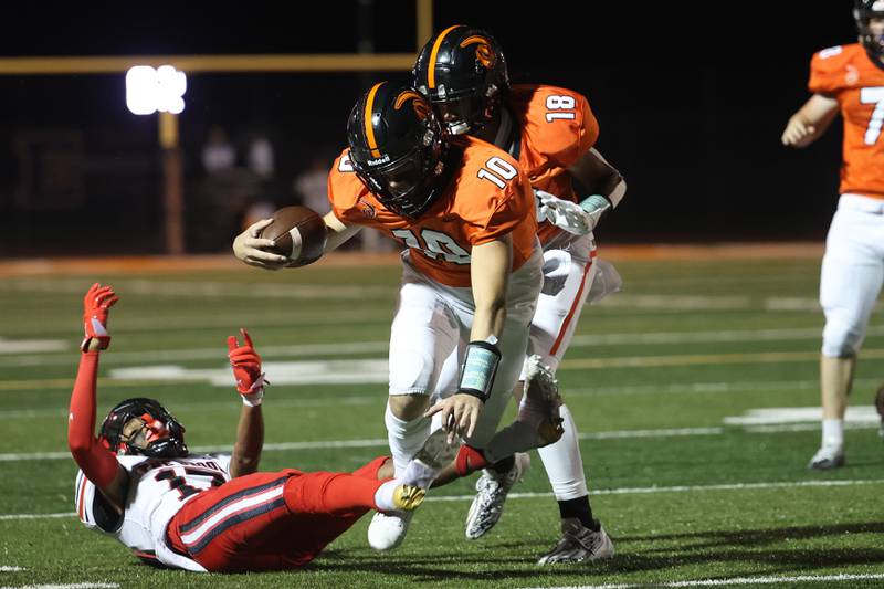 Lincoln-Way West’s Chase Hetfieisch gets tripped up on a first down run against Bolingbrook on Friday, Sept. 22 in New Lenox.
