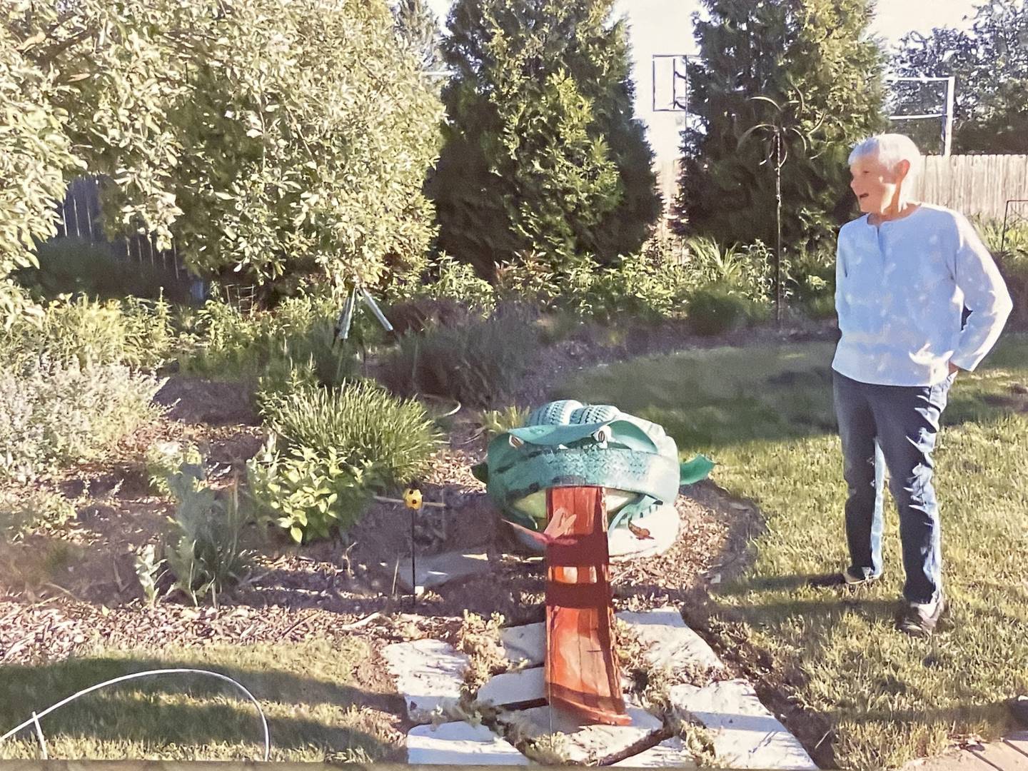 DeKalb resident Joyce Marten (right) is seen standing in her yard near the cistern for irrigation, which allows her to use rain water instead of city water to tend to her garden. The Marten family garden is located 102 Buena Vista Drive in DeKalb.