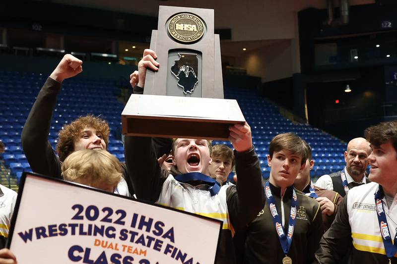 Joliet Catholic’s Hunter Powell host up the championship trophy after defeating Deerfield’s in the Class 2A dual team championship at Grossinger Motor Arena in Bloomington. Saturday, Feb. 26, 2022, in Champaign.