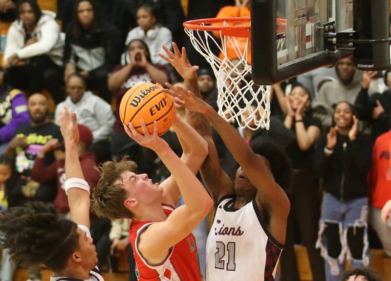 L-P's Jameson Hill has his shot blocked by Peoria's LeShawn Stowers during the Class 3A Sectional semifinal game on Wednesday, March 5, 2025 at Washington High School.