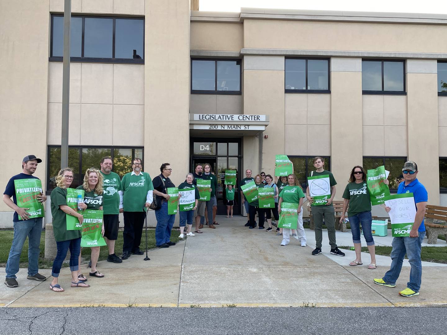 Members of the American Federation of State, County and Municipal Employees #3537, stand outside the Legislative Center in Sycamore ahead of the DeKalb County Board Wednesday, June 15, 2022 imploring the board to vote no on a proposed sale of the struggling DeKalb County Rehabilitation and Nursing Center.