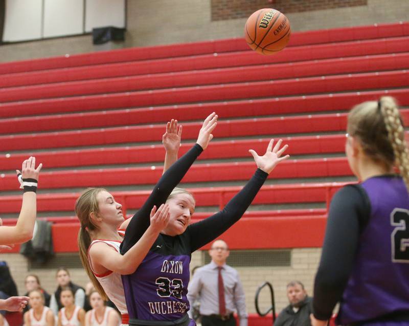 Dixon's Jessie Pitman losses control of the ball as Ottawa's Ashlynn Ganiere defends on Wednesday, Nov. 29, 2023 at Kingman Gym.