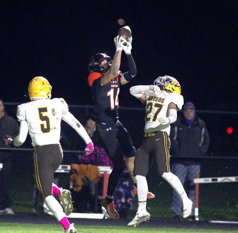 Crystal Lake Central’s George Dimopoulos, center, makes a touchdown reception as Jacobs’ Justin Gonzalez (27) looks for the ball in varsity football at Metcalf Field on the campus of Crystal Lake Central Friday night.
