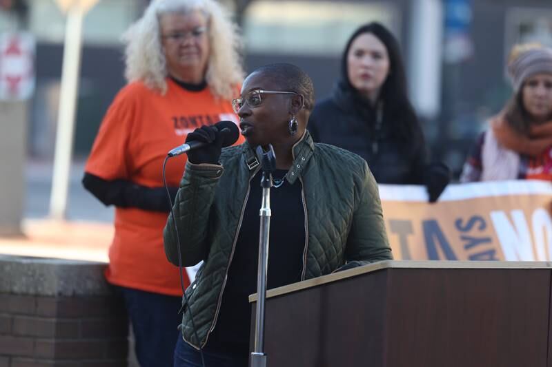 Reclaim 13 survivor advocate Tomitra Fluker speaks during a rally for ZONTA Says No To Violence Against Women outside the old court house on Tuesday in Joliet.