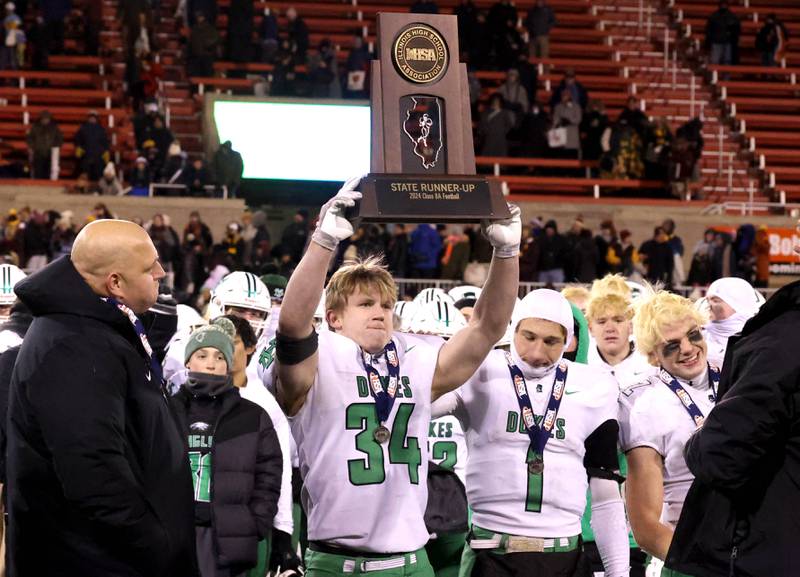 York’s Jimmy Conners holds the state second place trophy after their Class 8A state championship game loss to Loyola Saturday, Nov. 30, 2024, in Hancock Stadium at Illinois State University in Normal.