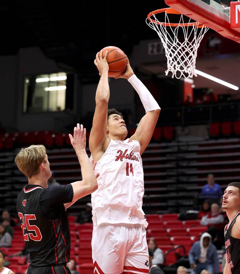 Northern Illinois' Yanic Konan Niederhauser goes by Illinois Tech's Andrew Veon for a dunk during their game Monday, Nov. 13, 2023, at the NIU Convocation Center in DeKalb.