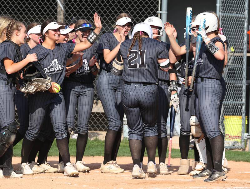 Kaneland's Addison Coulter is mobbed by her team as she touches home plate after homering during their game against Sycamore Wednesday, May 7, 2025, at Kaneland High School in Maple Park.