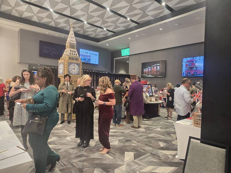 Guests attending the Shorewood HUGS' "Lovely London: A Big Ben Bash" 2026 chocolate ball fundraiser mingle near a replica of Big Ben, created by Joliet Public Library former youth services clerk Jan Stack, on Saturday, Feb. 7, 2026, at Hollywood Casino Joliet.