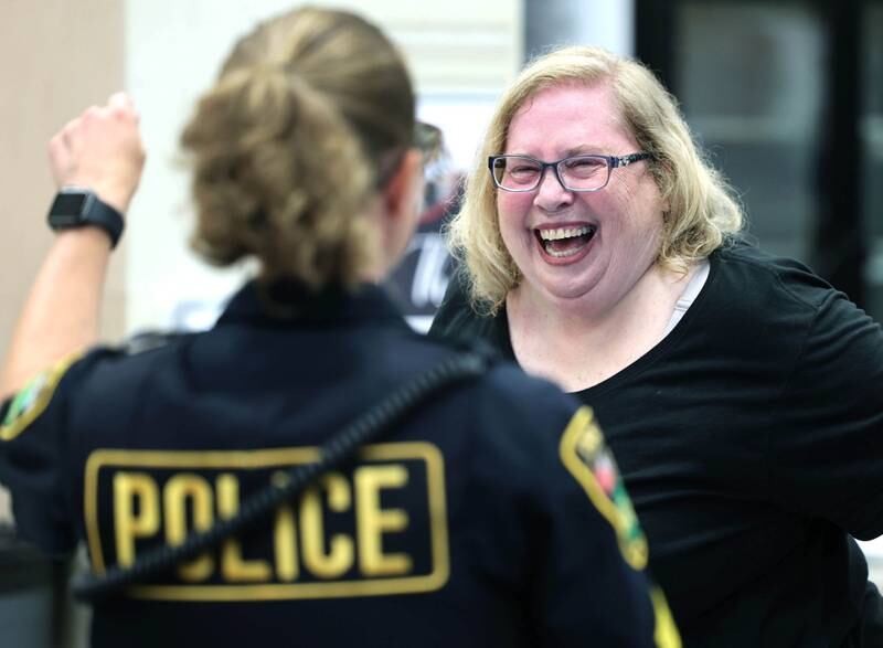Peggy Seiler, from Sycamore, has a laugh with Sycamore Police Sergeant Stacy Binkowski at the senior health fair Wednesday, July 12, 2023, at DeKalb High School.