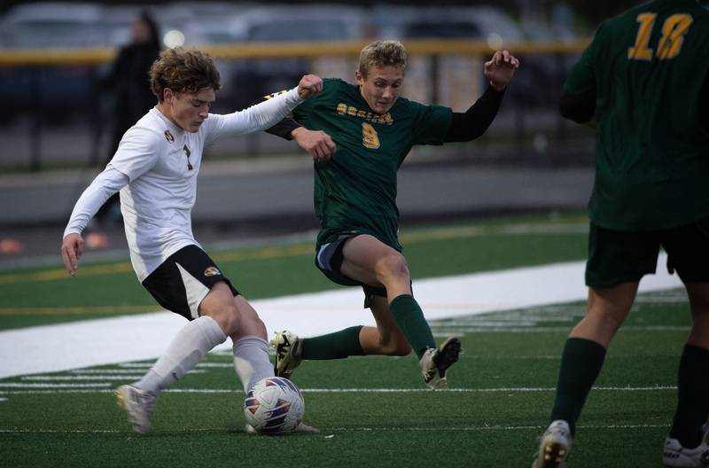 Herscher's Jacob Benoit, left, moves the ball down field as Coal City's Luke Munsterman defends during a sectional game on Tuesday, October 28, 2025.