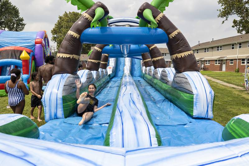 Natalee Fresco, 14, gets to the end of her water slide ride Friday, Aug. 1, 2025, at the Coloma Township Homes in Rock Falls. The Whiteside County Housing Authority put together two days of fun for the kids to strengthen community relations.