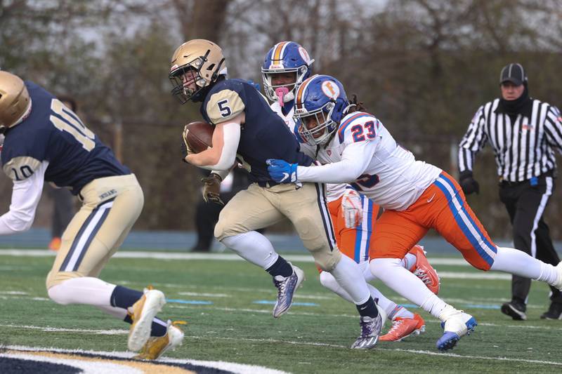 Lemont’s Nate Wrublik drags several East St. Louis defenders on a run in the Class 6A semifinal in Lemont on Saturday.