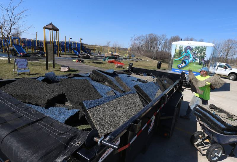 Aaron Bristow of Teim Reil Inc. removes pieces of the surface of the playground at Rotary Park on Monday, March 11, 2024 in La Salle. The playground will be re-surfaced and completed on March 25. The playground will be closed until work is finished.