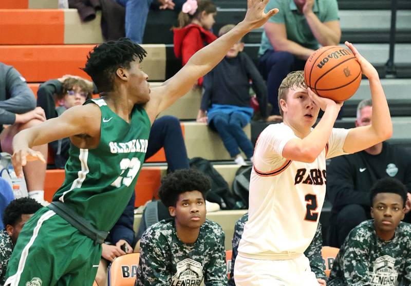 DeKalb's Sean Reynolds gets up a 3-pointer just ahead of the defense of Glenbard West's Benji Zander during their game Tuesday, Nov. 29, 2022, at DeKalb High School.