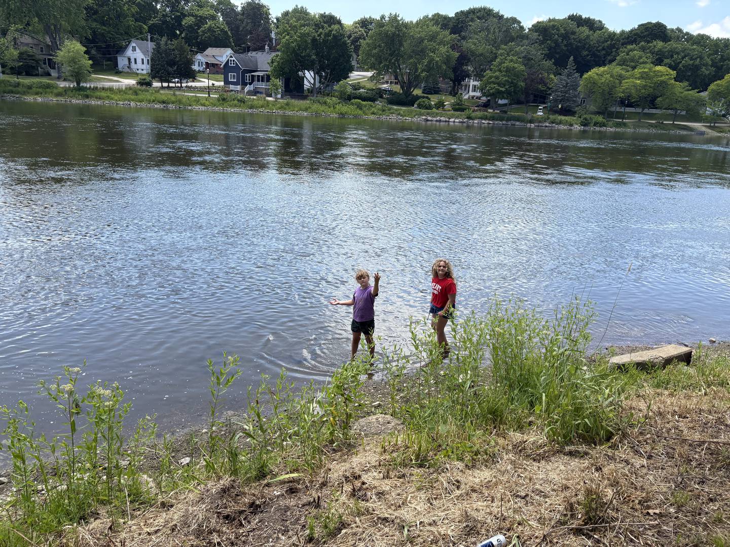 Izzy Porter, 8, of Sleepy Hollow holds up a clamshell in the Fox River, alongside Tallulah Porter, 10, of Sleepy Hollow, after the "El Cardunal" paddle June 22, 2025.