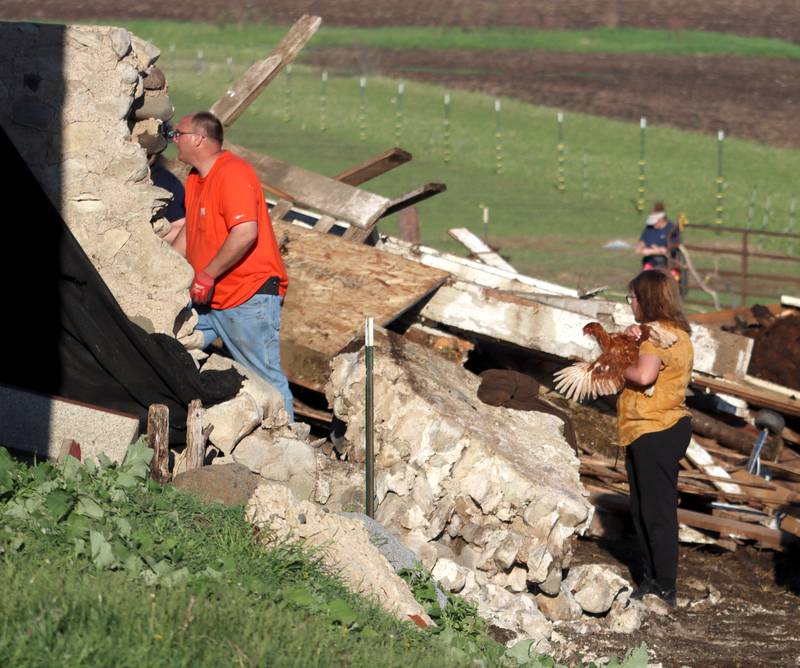 First responders and property owners tend the scene of a barn collapse along Weidner Road near Harvard on Tuesday evening.